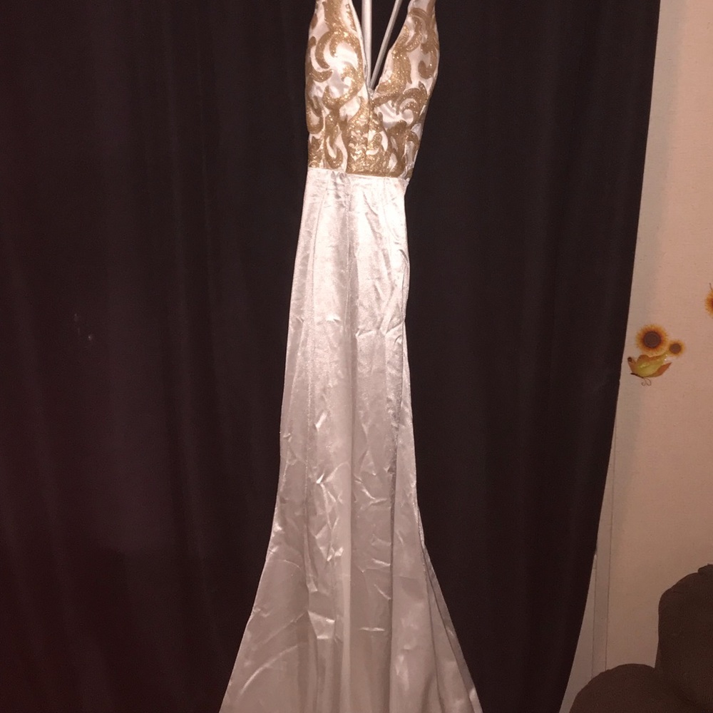 It’s. A gold &white prom dress not worn at all brand new